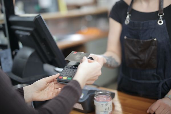 Customer using wireless card terminal in a shop